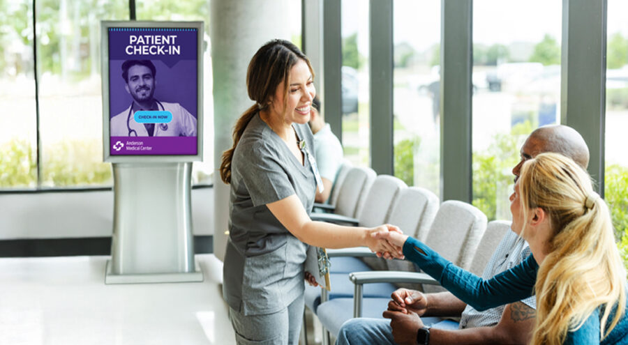 Nurse and patients with waiting room digital signage