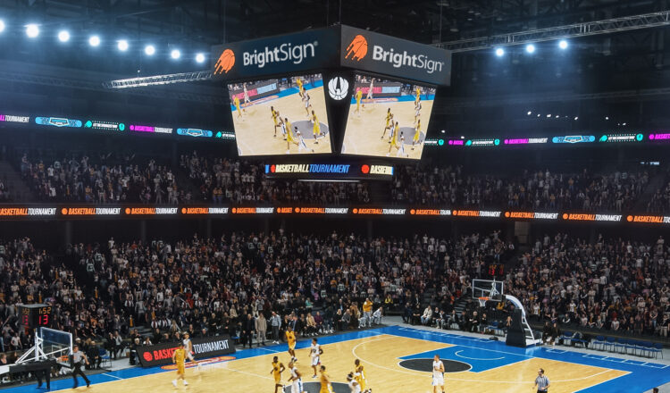 Basketball game with sports stadium signage