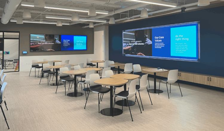 Office breakroom with corporate digital signage branding and messaging