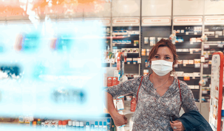 Woman wearing a mask in a retail store looking at a display